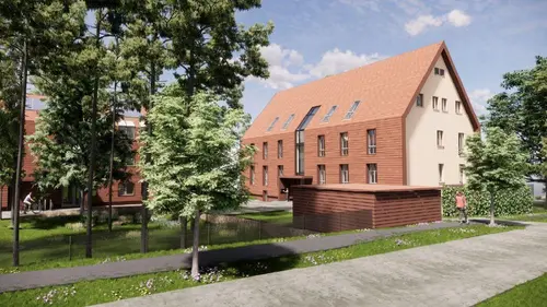 Ein Gebäude mit Fußweg in einem kleinen Park mit Bäumen