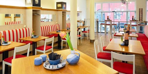 Blick in den Gastraum des Lichtblick mit Gasttischen, Stühlen und Tischdekoration