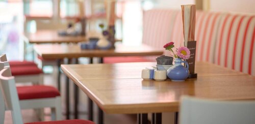 Gastronomie & Hotellerie Blick in eine Gaststätte auf einen Tisch mit einer Blume