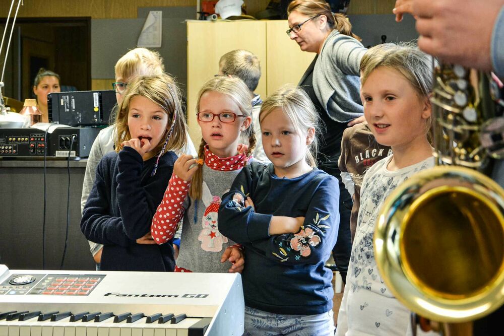 Die Grundschüler aus Greifswald schauen gespannt zu den Instrumenten der Band
